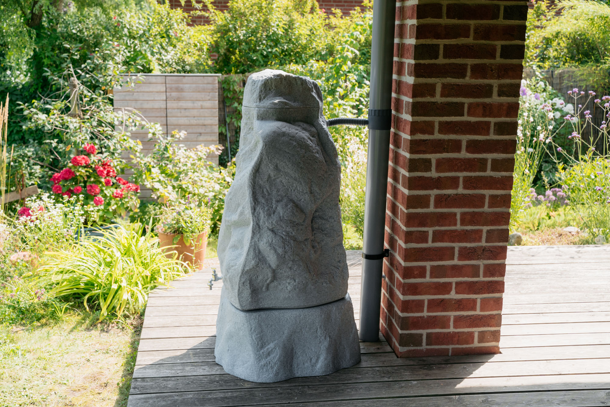 Regenspeicher verbunden ans fallrohr mit dem retomaten auf der terasse